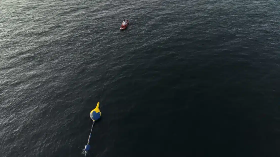 Aerial view of CorPower Ocean's wave energy converter and support vessel at sea.