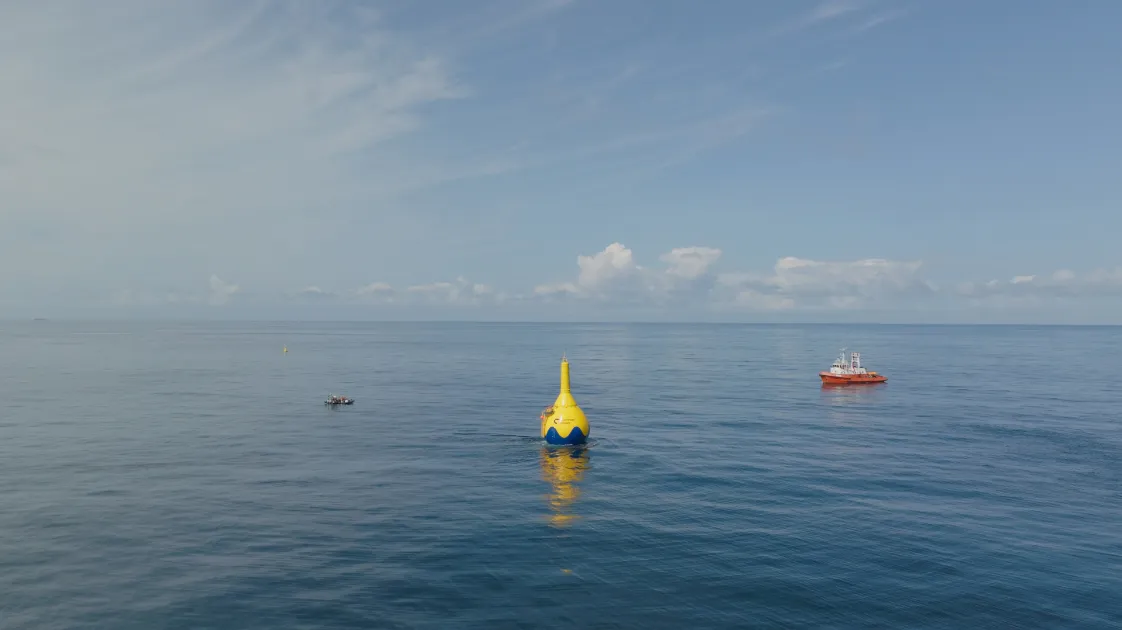 CorPower Ocean's advanced wave energy converters and support vessel in a calm ocean.