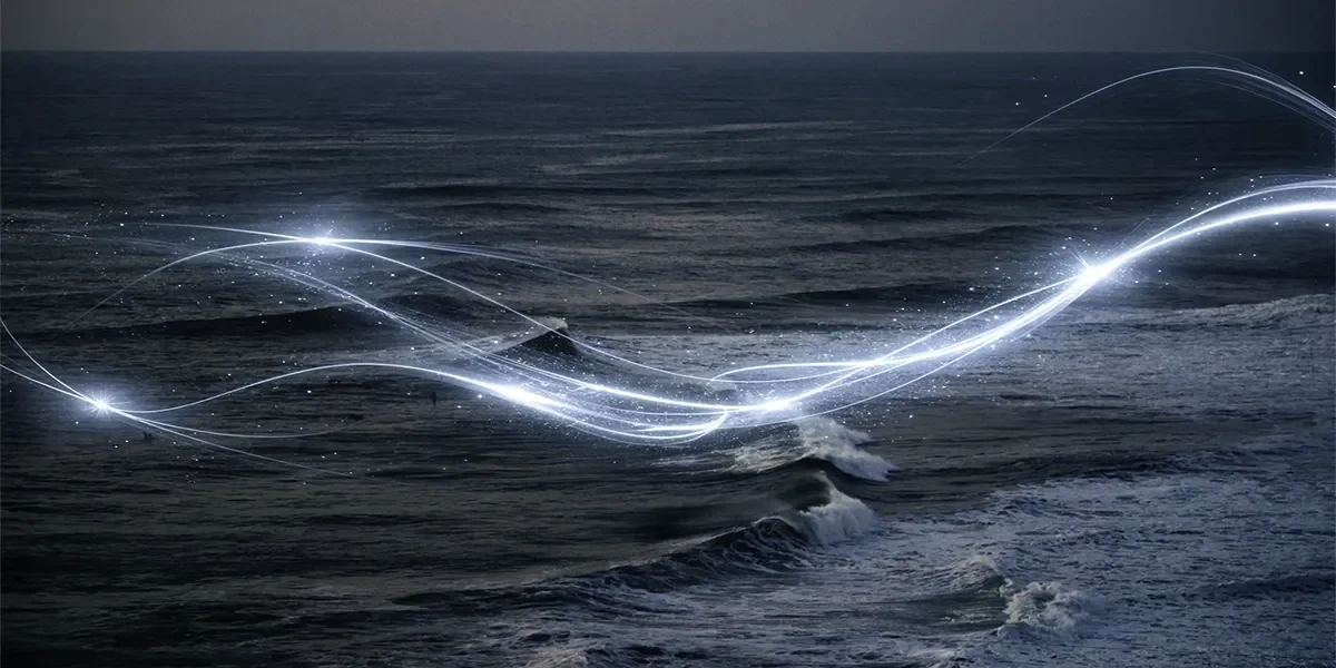 Wave energy visualized as flowing energy lines over ocean surface representing 24/7 clean power generation